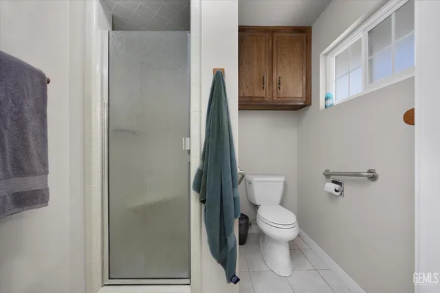 a white toilet sitting next to a bathroom sink