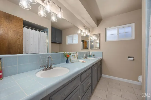 a bathroom with a double vanity sink and a mirror
