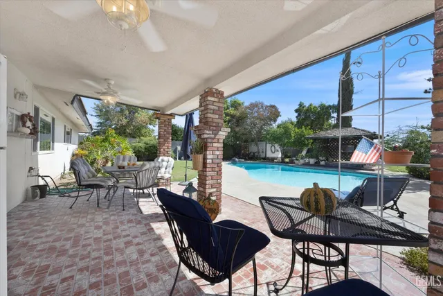 a dining room with furniture and a floor to ceiling window