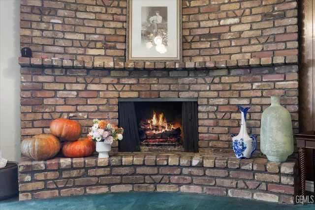 a living room with fireplace furniture and a fireplace