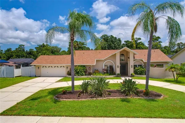 front view of house with a yard and potted plants