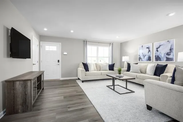 a living room with furniture and a flat screen tv