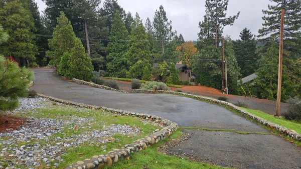 a view of a garden with a building in the background