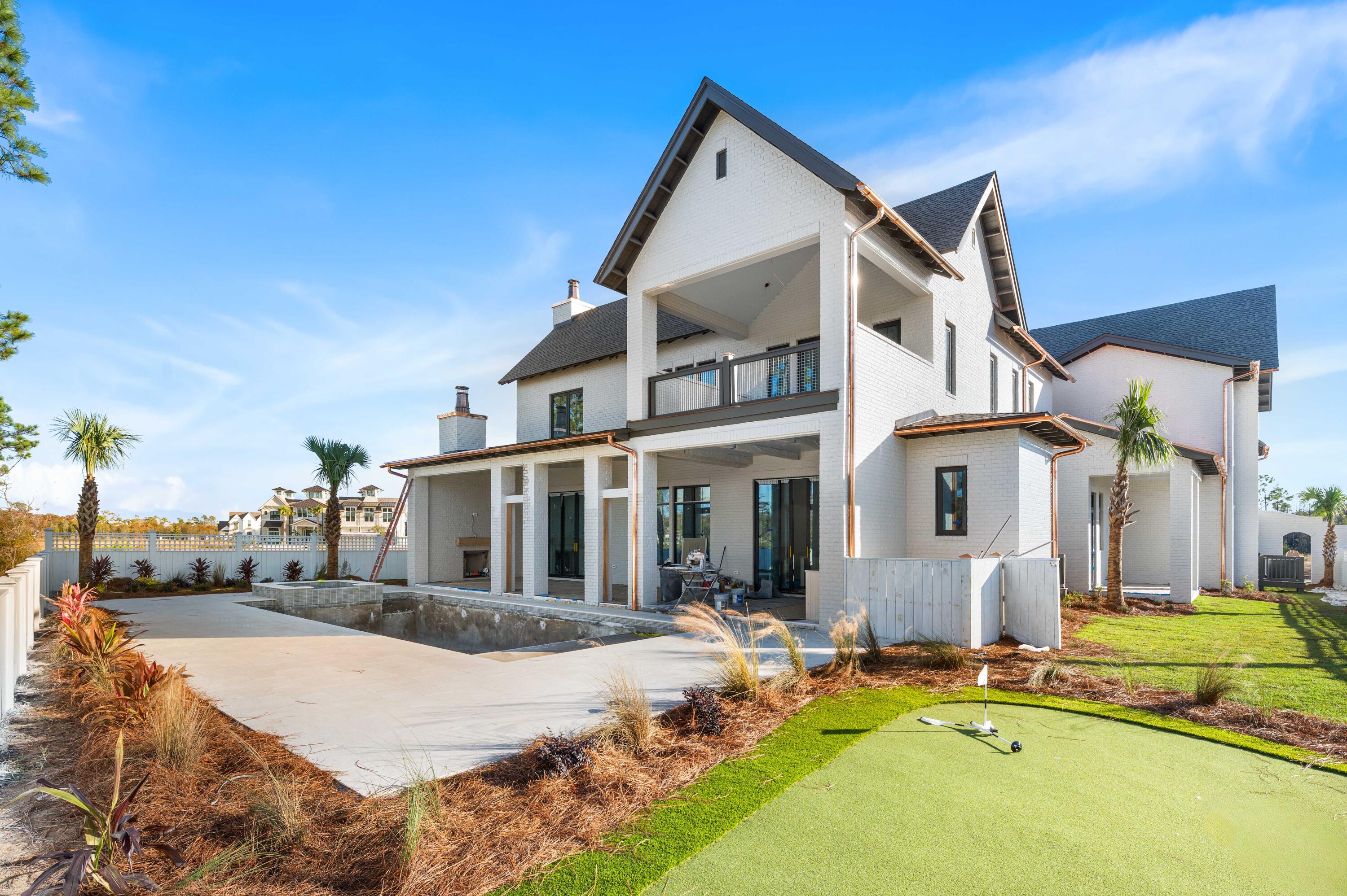 158 Sandcord Dr Inlet Beach Inlet Beach, FL 32461 - Photo 4 of 53 a view of a white house with swimming pool lawn chairs and a yard