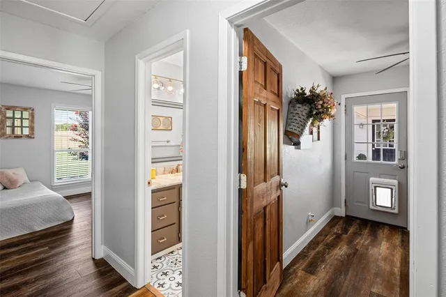 a living room with furniture a chandelier and a window