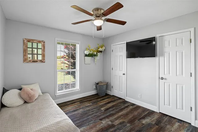 a bathroom with a granite countertop sink a toilet and shower