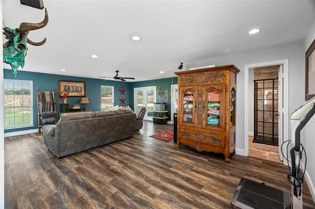 a bedroom with a large bed a chandelier and a window