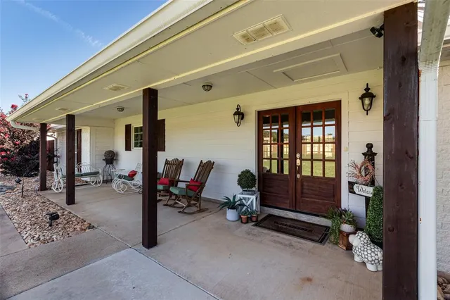 a living room with furniture gym equipment and a chandelier
