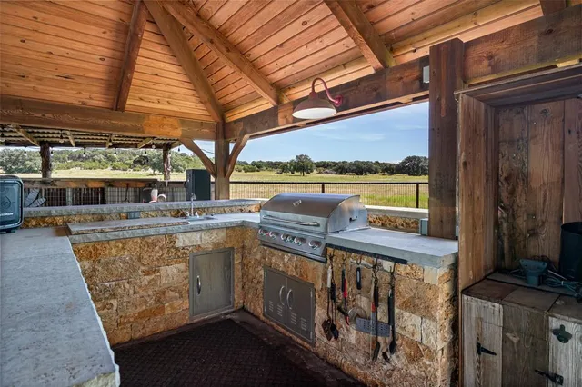 a view of a patio with table and chairs under an umbrella