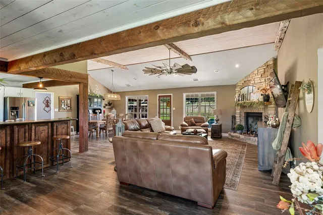 a living room with fireplace furniture and a flat screen tv