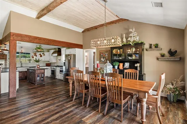 a kitchen with a sink dishwasher and white cabinets with wooden floor