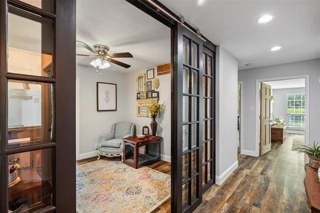 a living room with furniture a fireplace and a chandelier