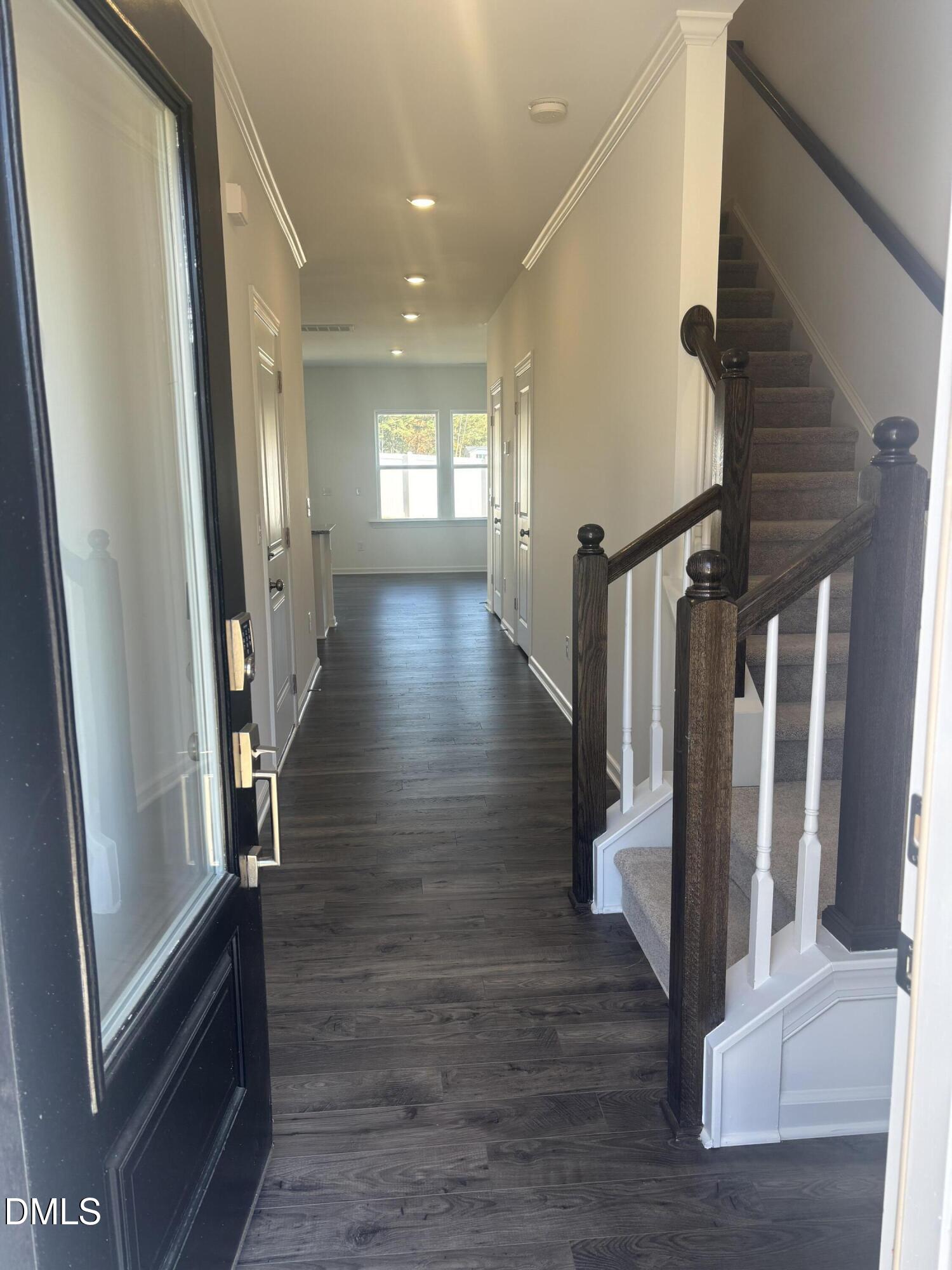 272 Hank Way Willow Spring, NC 27592 - Photo 5 of 19 a view of a hallway with wooden floor and staircase