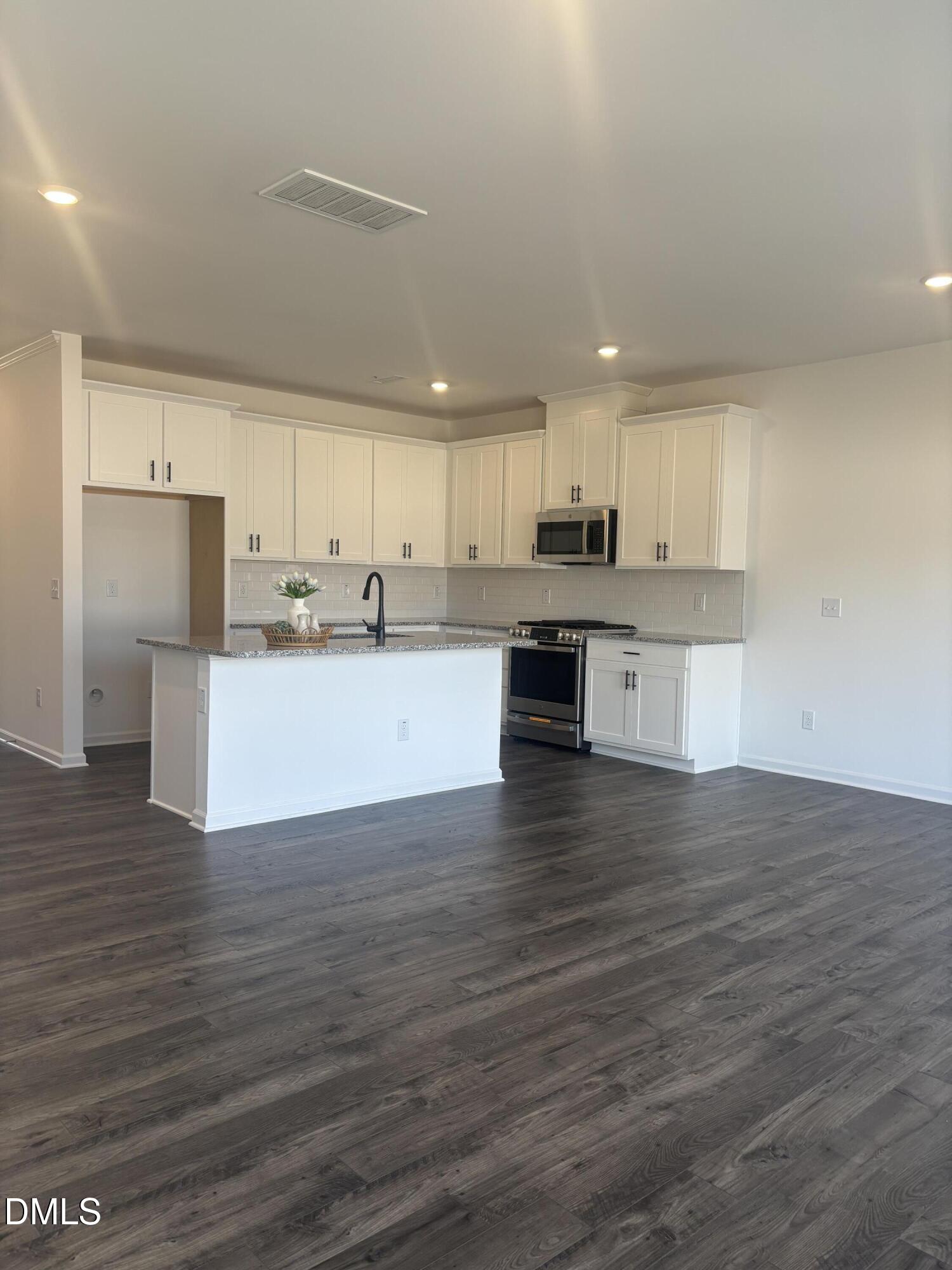 272 Hank Way Willow Spring, NC 27592 - Photo 6 of 19 a view of kitchen with wooden floor and window