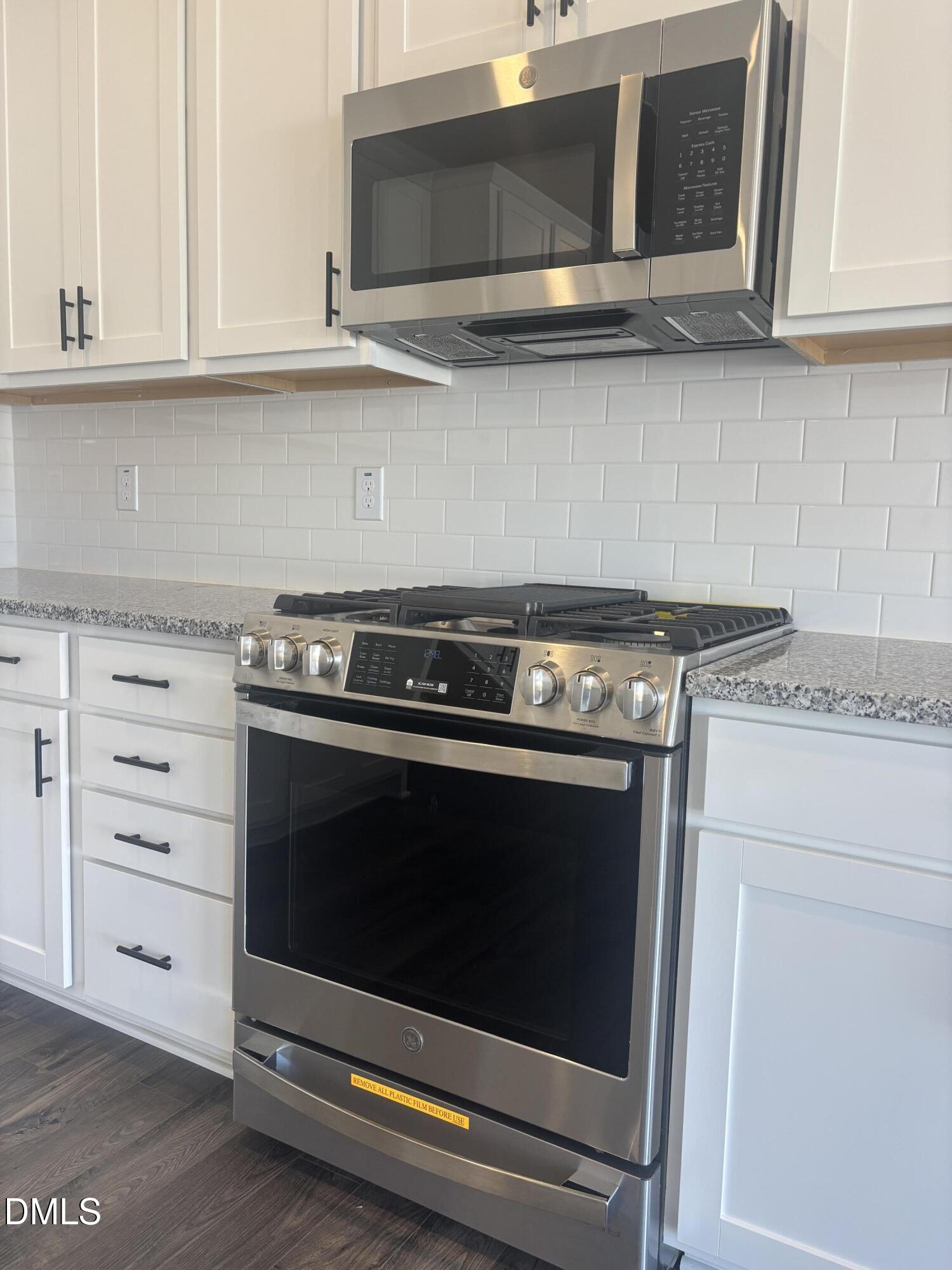 272 Hank Way Willow Spring, NC 27592 - Photo 8 of 19 a stove top oven sitting inside of a kitchen and granite counter tops