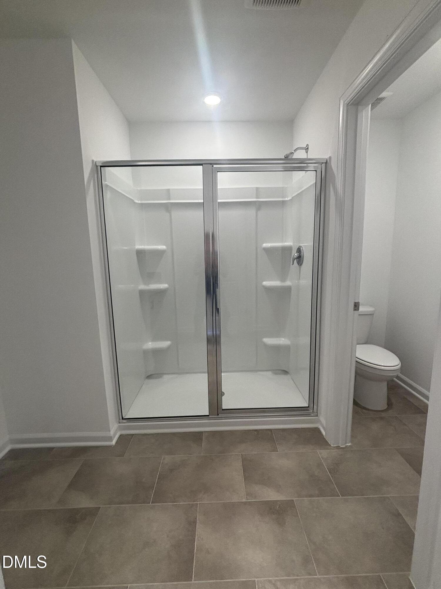 272 Hank Way Willow Spring, NC 27592 - Photo 9 of 19 a bathroom with a glass door shower