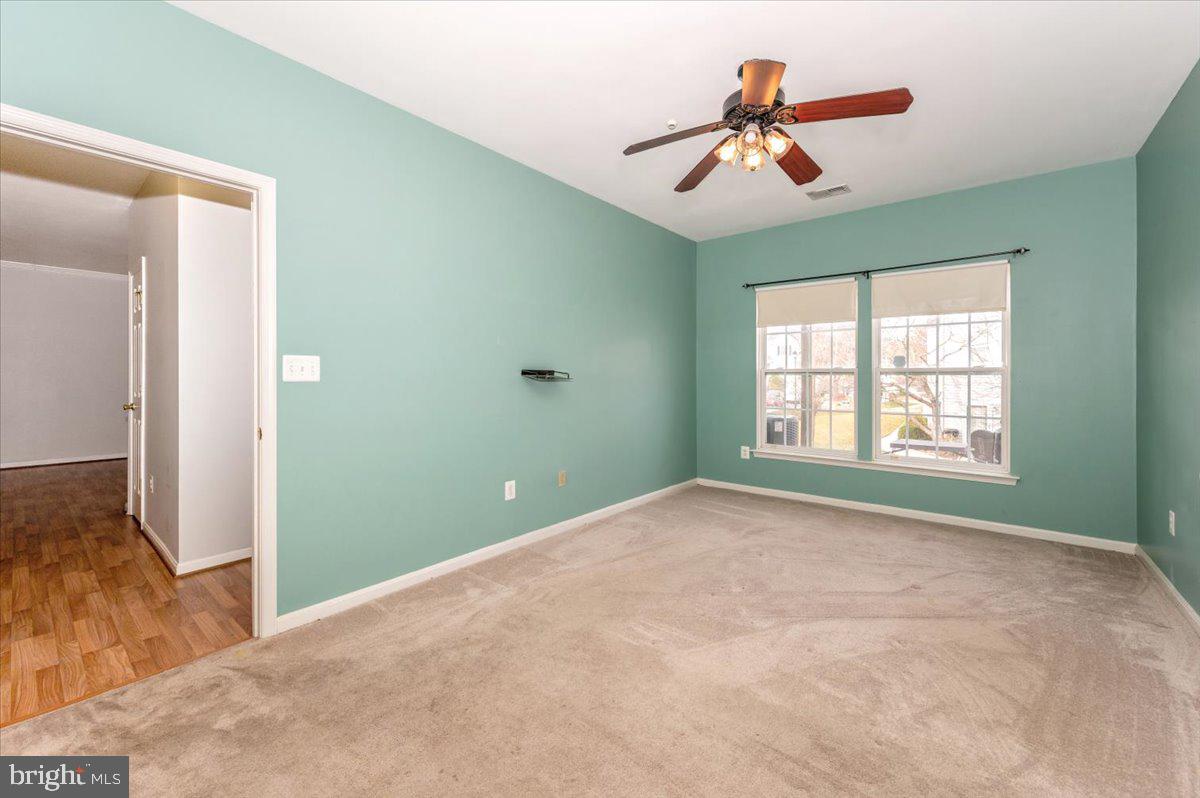 1683 Fallowfield Court Crofton, MD 21114 - Photo 18 of 36 a view of a room with window a ceiling fan and carpet