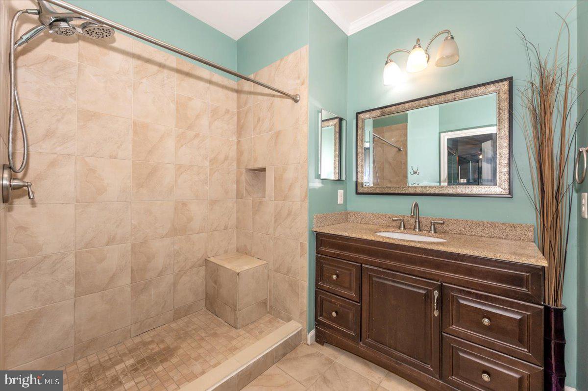 1683 Fallowfield Court Crofton, MD 21114 - Photo 22 of 36 a bathroom with a sink and a mirror