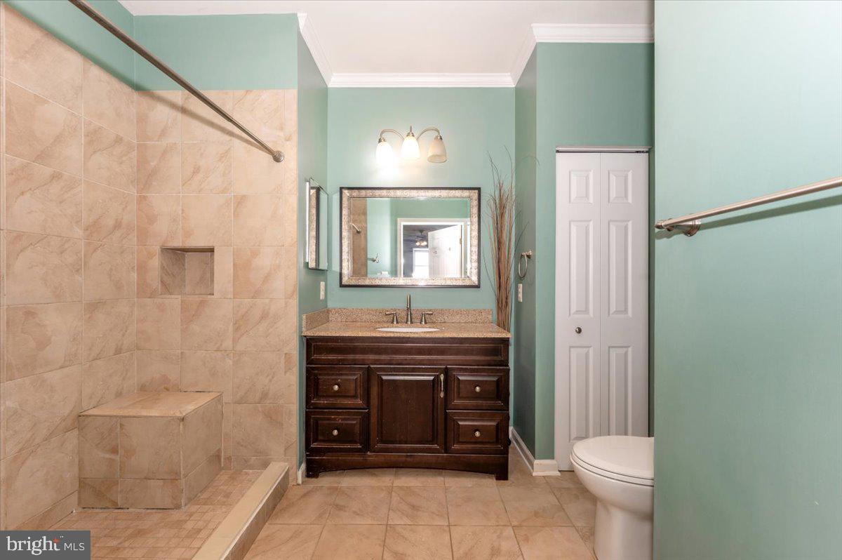 1683 Fallowfield Court Crofton, MD 21114 - Photo 23 of 36 a bathroom with a toilet a sink and mirror