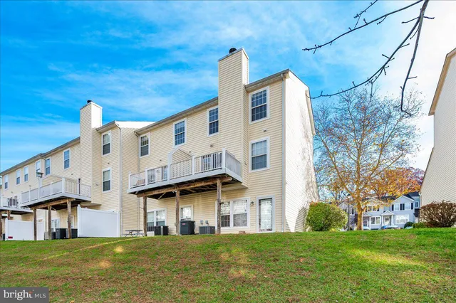 a view of a house with backyard porch and sitting area