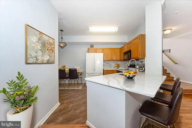a kitchen view with living room stove and a refrigerator