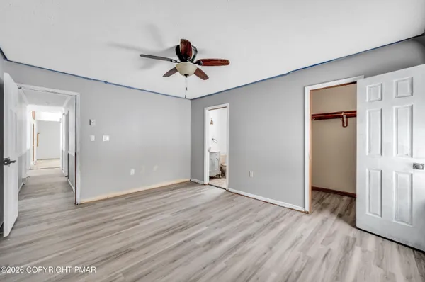 a view of an empty room and wooden floor