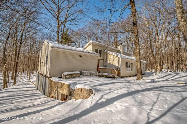 a view of a building with car parked on the road