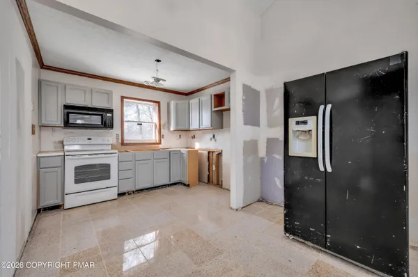 a kitchen with white cabinets and stainless steel appliances