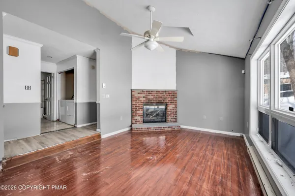 wooden floor in an empty room with a fireplace