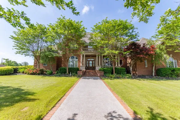 a kitchen with stainless steel appliances granite countertop a sink a stove and a refrigerator