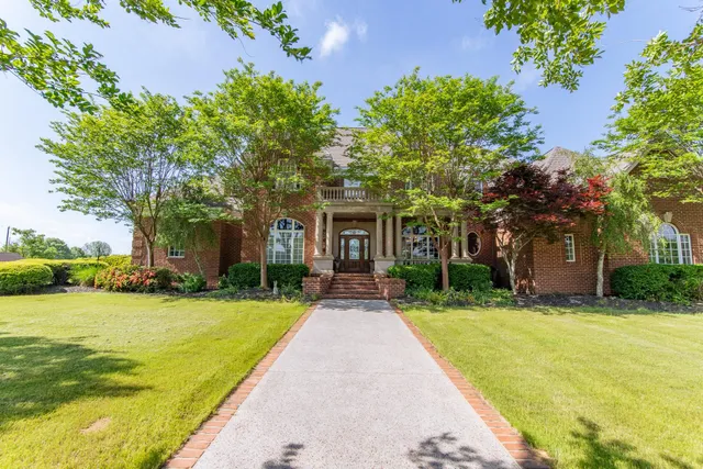 a view of a house with swimming pool and a garden