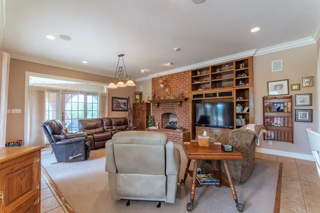 a living room with fireplace furniture and a flat screen tv