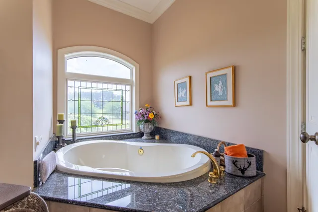 a white bath tub sitting next to a window
