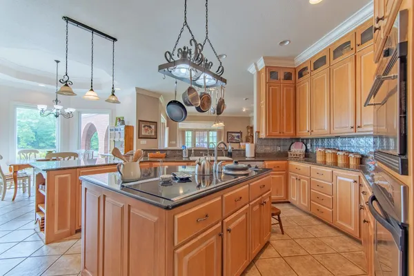 a kitchen with stainless steel appliances granite countertop a stove and a sink