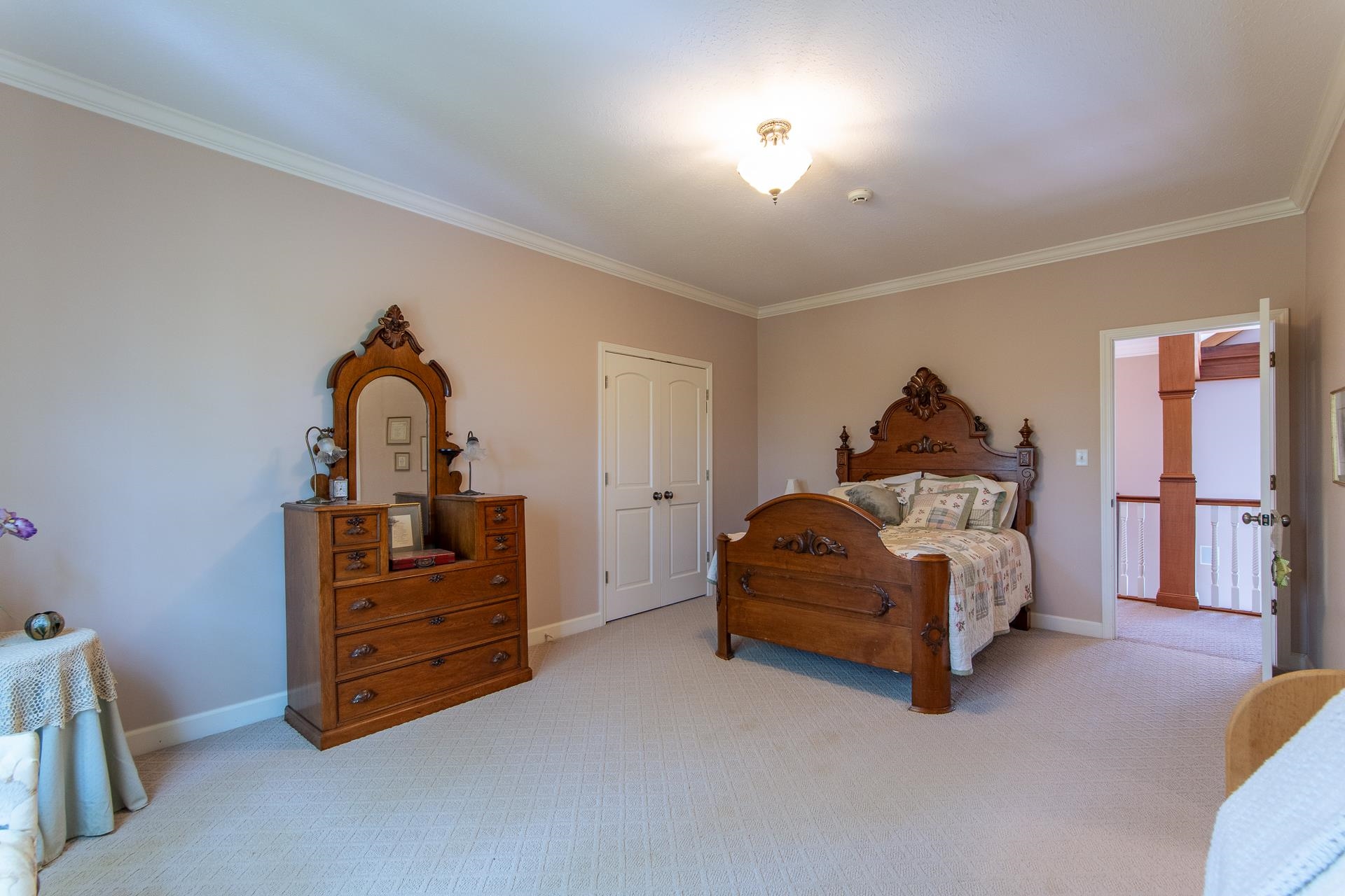 4265 Charlie Pounds Road Stantonville, TN 38379 - Photo 25 of 40 a spacious bedroom with a bed and a chandelier
