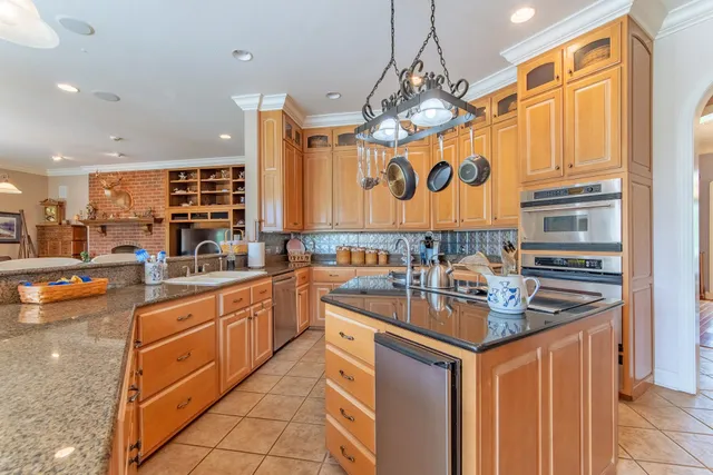 a kitchen with stainless steel appliances granite countertop a sink and cabinets