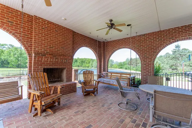 an aerial view of a house with a yard and lake view