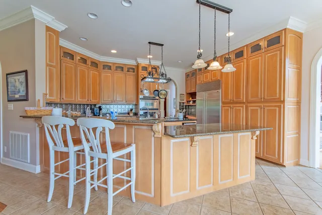 a view of a kitchen with wooden floor and windows