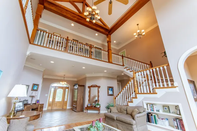 a living room with furniture and a chandelier