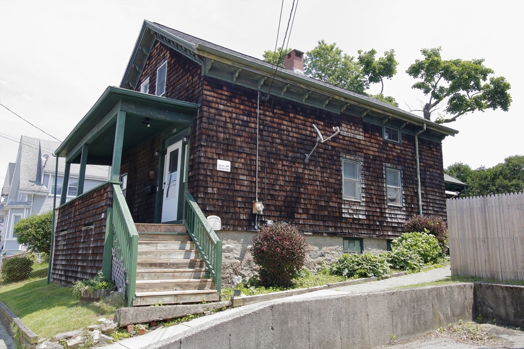 100 Ridge Street Fall River, MA 02721 - Photo 1 of 22 a front view of a house with a garden