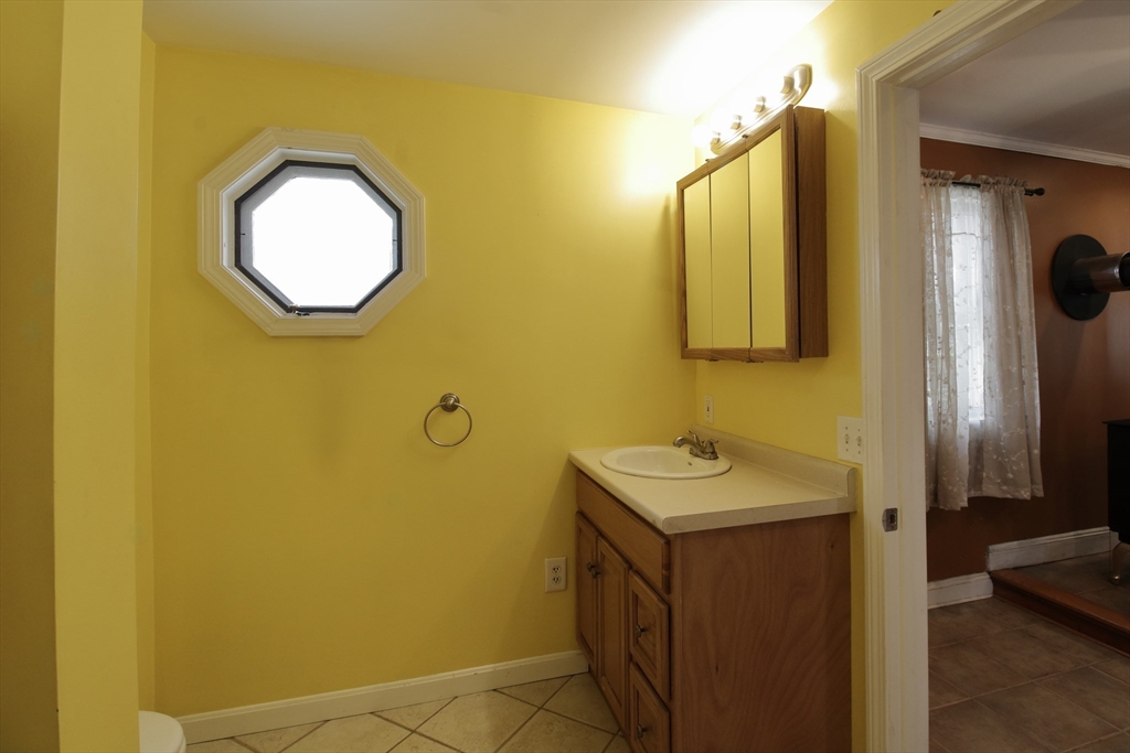 100 Ridge Street Fall River, MA 02721 - Photo 11 of 22 a bathroom with a sink and a mirror