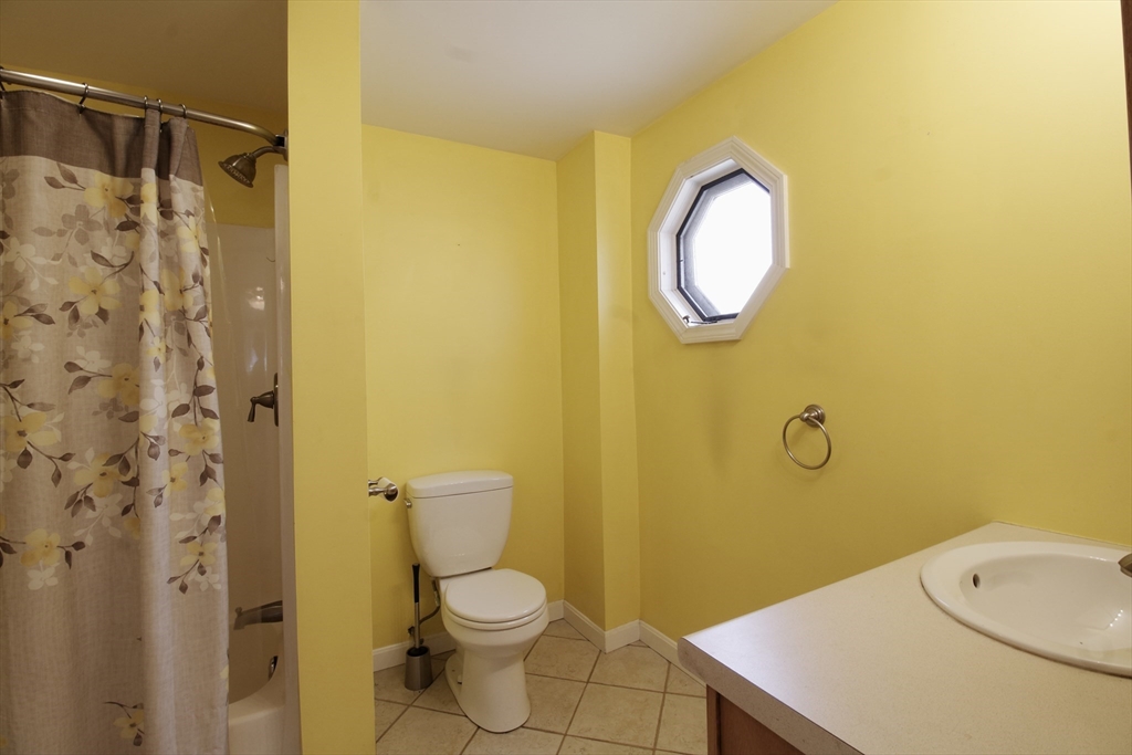 100 Ridge Street Fall River, MA 02721 - Photo 12 of 22 a bathroom with a toilet sink vanity and shower