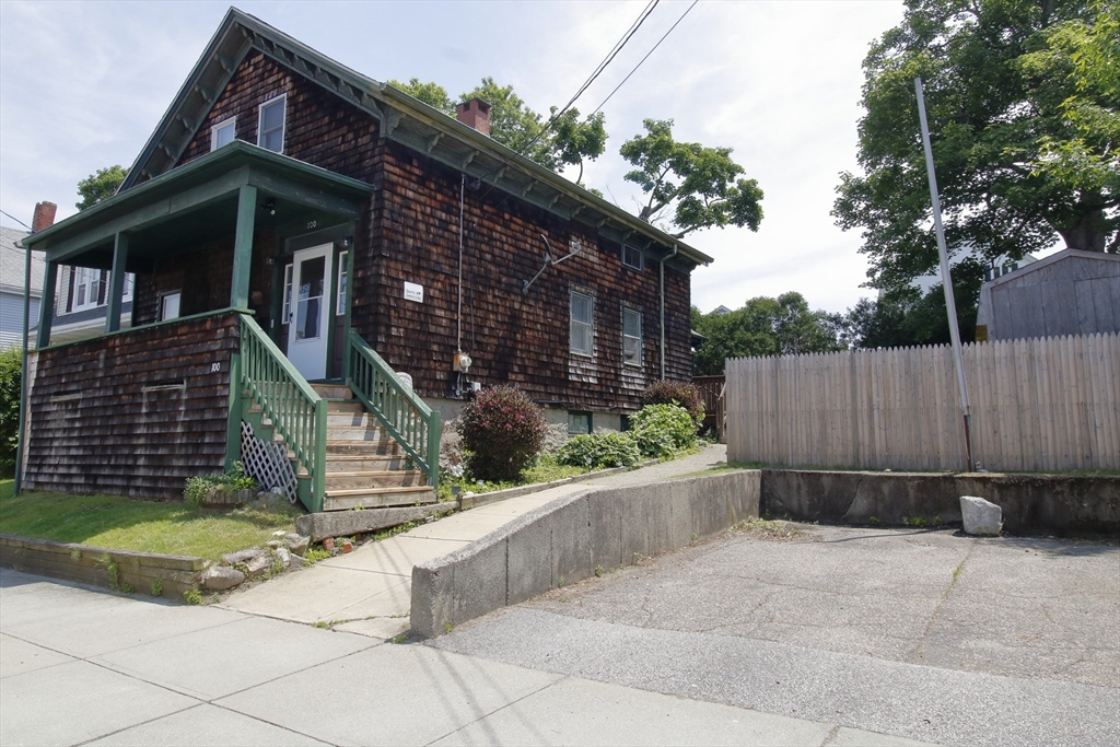 100 Ridge Street Fall River, MA 02721 - Photo 2 of 22 a view of a house with a small yard and wooden fence