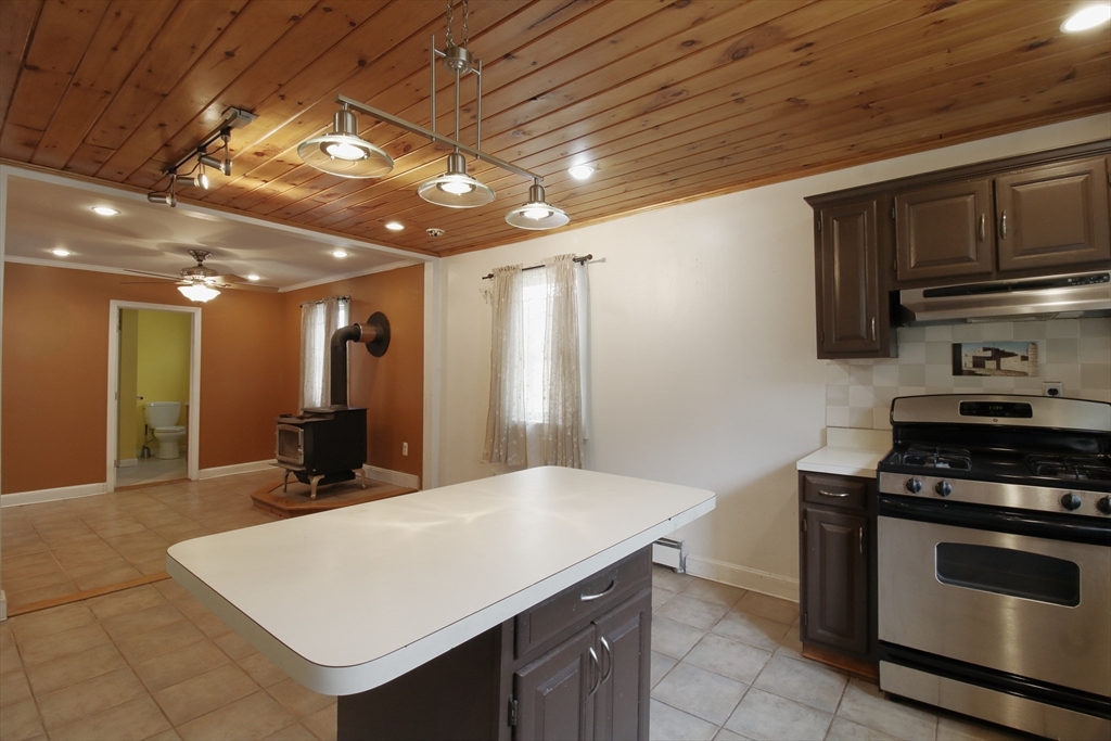 100 Ridge Street Fall River, MA 02721 - Photo 8 of 22 a kitchen with kitchen island a sink stove and refrigerator
