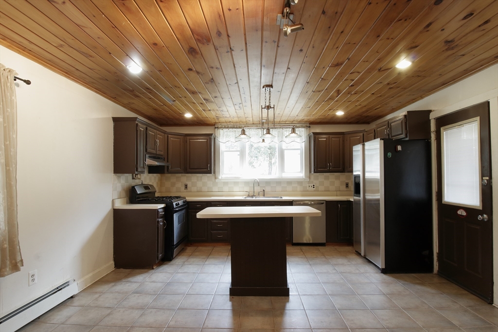 100 Ridge Street Fall River, MA 02721 - Photo 9 of 22 a kitchen with stainless steel appliances granite countertop a sink counter space cabinets and a counter top space