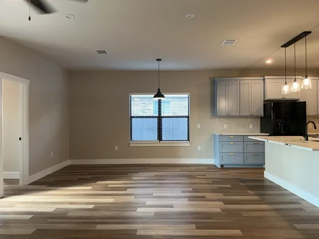 a kitchen with kitchen island a counter top space appliances and a window
