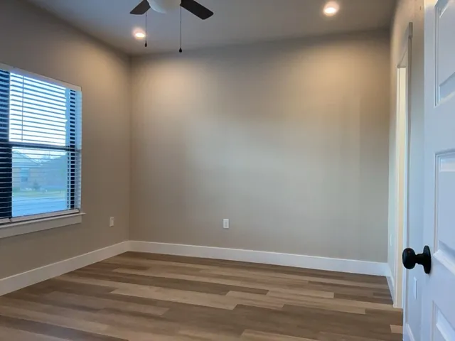 wooden floor with white cabinets