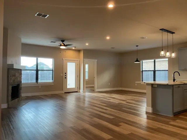 a view of a kitchen with a sink and a window