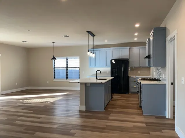 a kitchen with refrigerator and cabinets