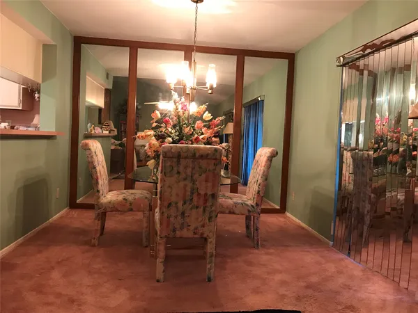 a dining room with furniture and chandelier kitchen view